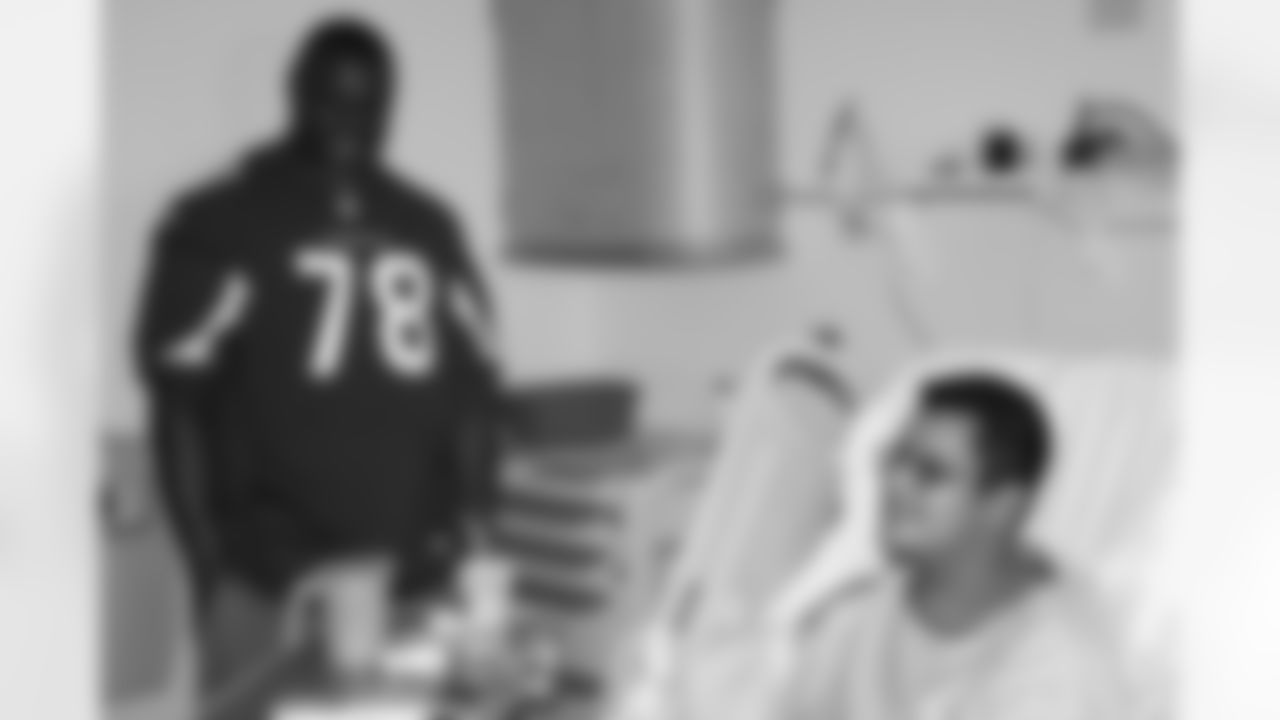 Offensive lineman Earl Watford hangs out with a patient.