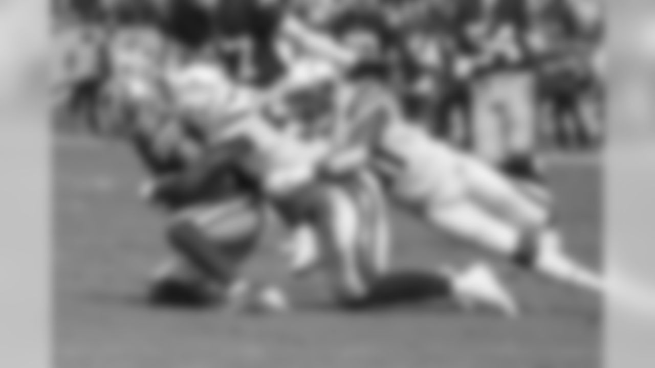 Jatavis Brown and Adrian Phillips tackle Dante Pettis during the Bolts' matchup against the 49ers at ROKiT Field at StubHub Center.