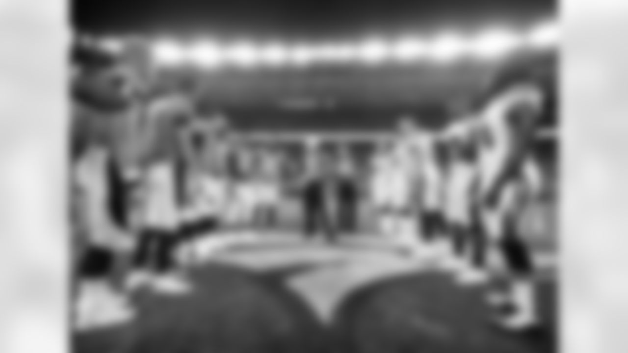 The Denver Broncos and the Los Angeles Chargers stand at mid field for the coin toss prior to an NFL football game, Monday, Sept. 11, 2017, in Denver. (AP Photo/Jack Dempsey)