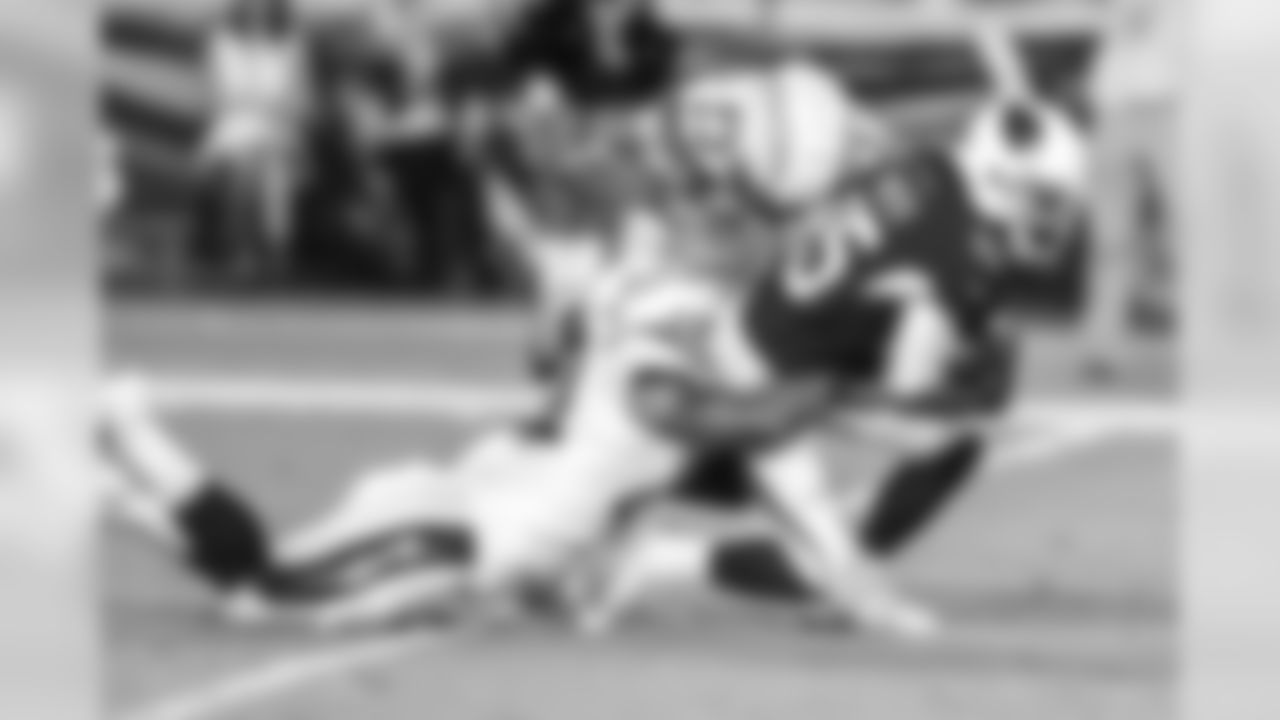 Jeff Richards and Kyzir White bring down Rashad Ross during the Chargers' first preseason game versus the Arizona Cardinals.