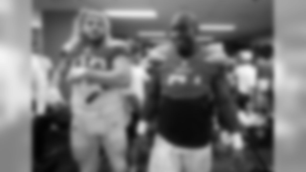 Sean Culkin and Damion Square celebrate the Bolts 26-10 victory over the Oakland Raiders in the locker room postgame.
