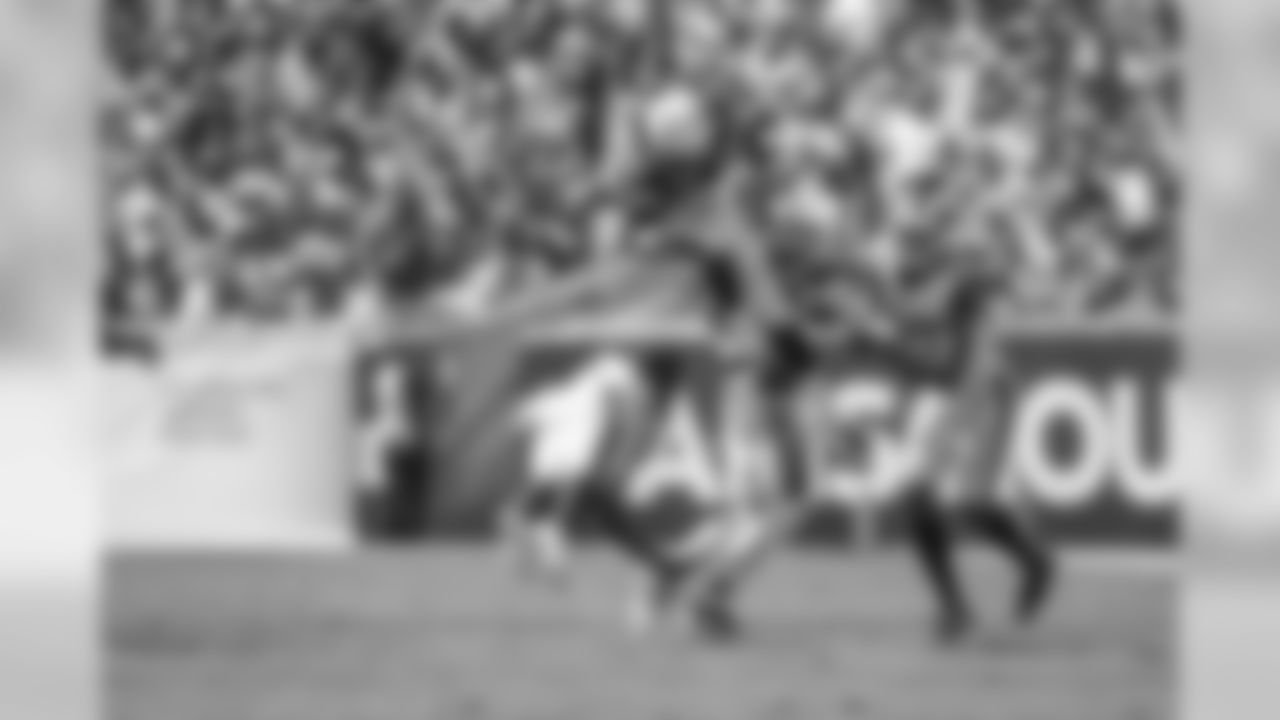 Melvin Gordon leaps over defenders during the Bolts' matchup against the LA Rams at the LA Memorial Coliseum.