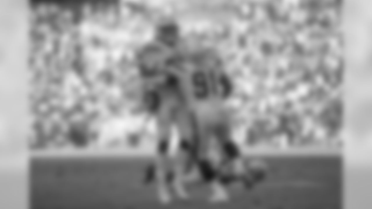 Isaac Rochell and Justin Jones celebrate Rochell's interception during the Bolts' matchup against the 49ers at ROKiT Field at StubHub Center.