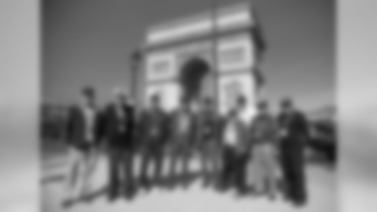 Veterans arrive in Paris and pose for a photo in front of the the Arc de Triomphe.