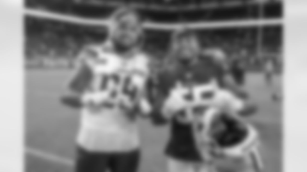 Sam Tevi after the game with former college teammate Pita Taumoepenu.