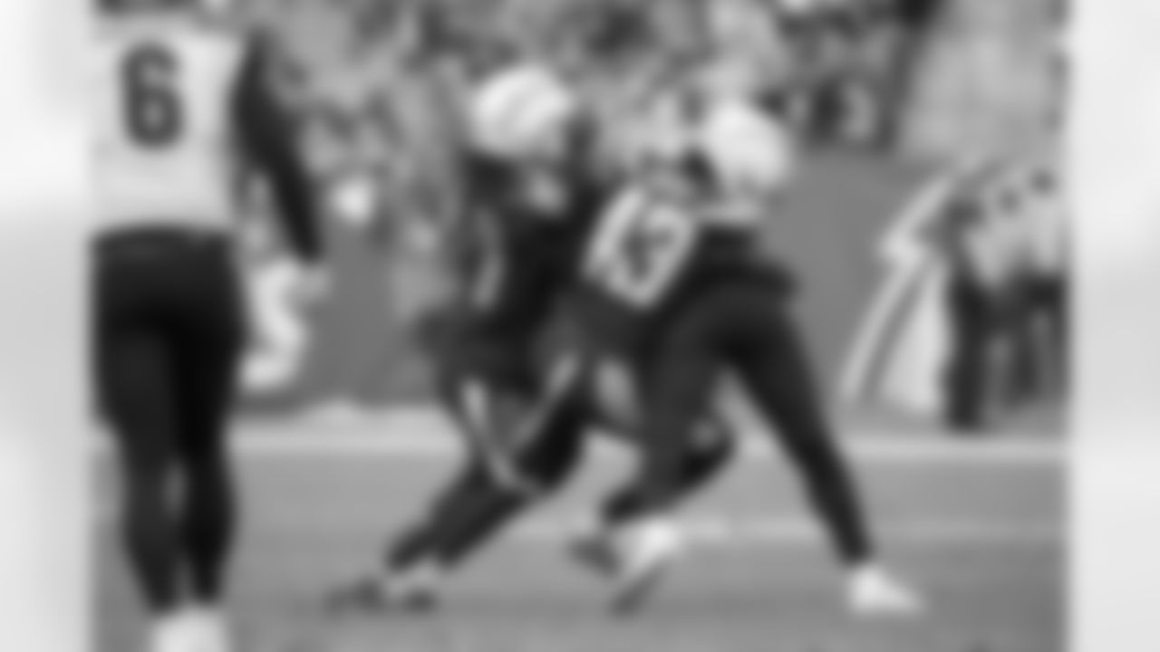 Jahleel Addae and Michael Davis tackle RB Joe Mixon during the Week 14 matchup against the Cincinnati Bengals at ROKiT Field at StubHub Center.