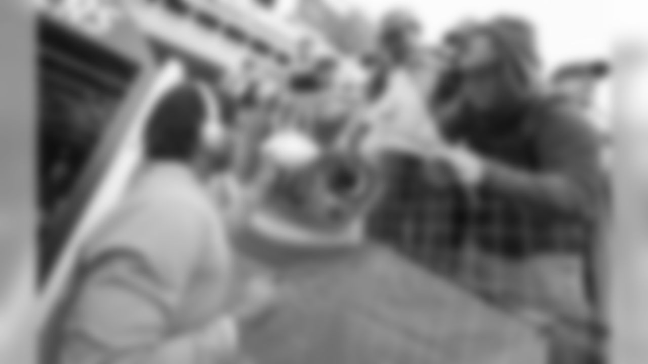 Virgil Green greets fans and signs autographs before the Week 14 matchup against the Cincinnati Bengals at ROKiT Field at StubHub Center.