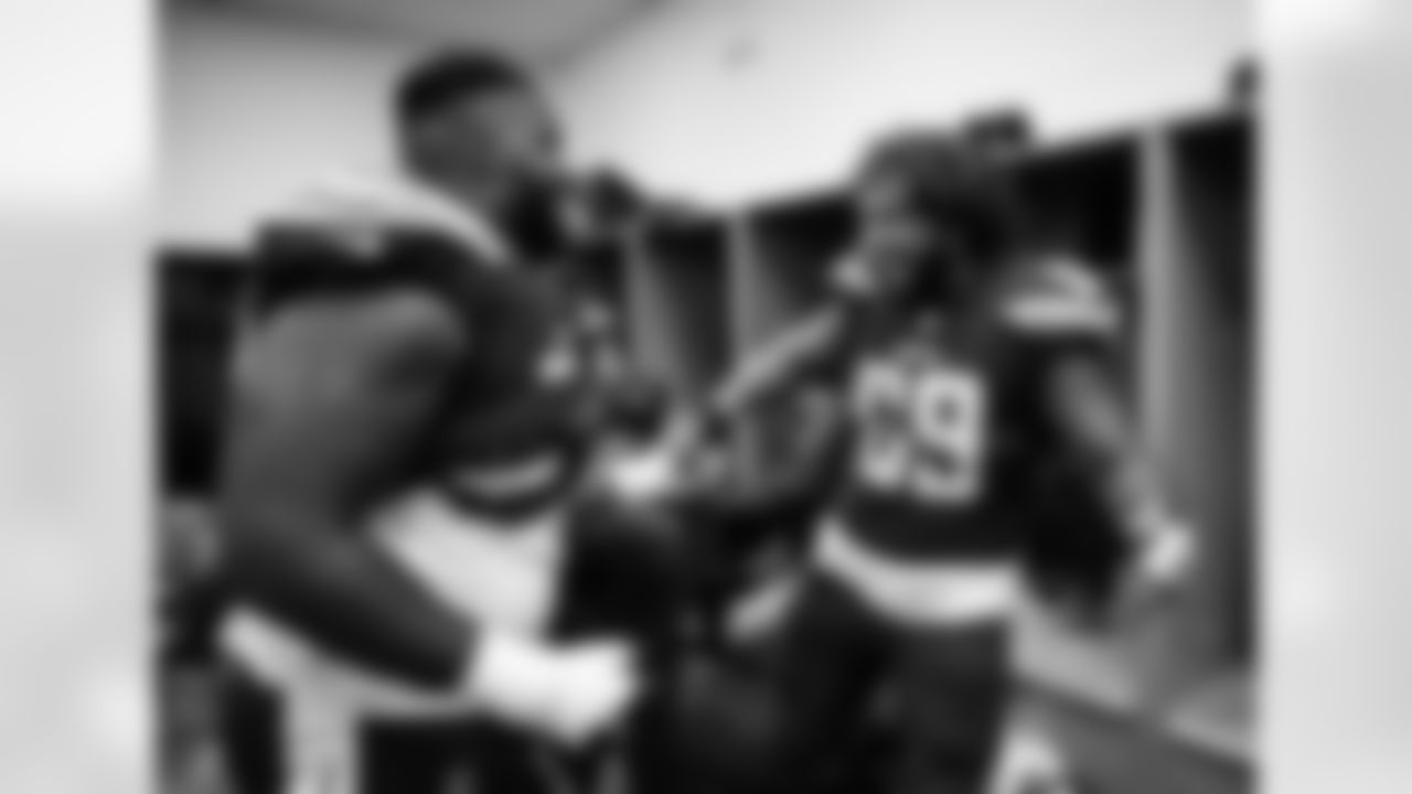Trent Scott and Sam Tevi celebrate the Bolts' 38-14 win over the Cleveland Browns in the locker room.