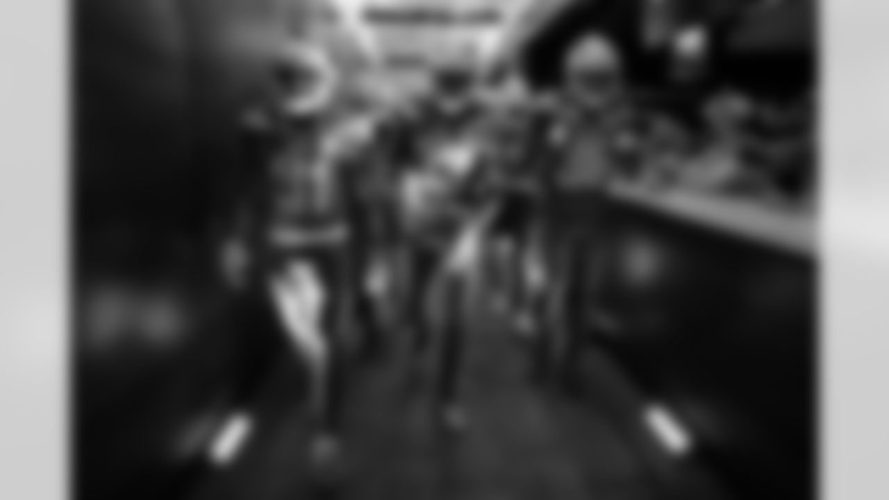 Adrian Phillips, Derwin James and Brandon Facyson walk through the tunnel to the field before the Week 12 matchup against the Arizona Cardinals.