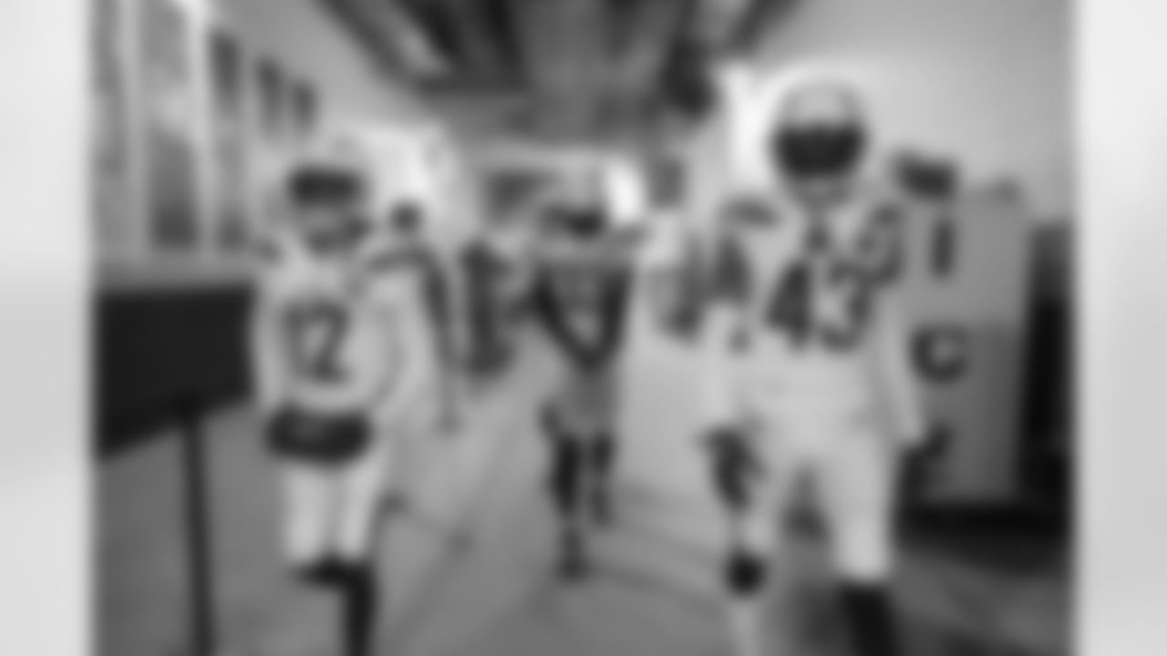 Travis Benjamin, Derwin James and Michael Davis walk out to the field before the Divisional Round matchup against the New England Patriots at Gillette Stadium.