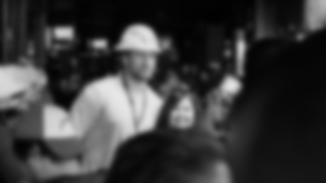 Sean Culkin poses with a fan while wearing a Chargers hard hat in Ensenada, Mexico during the Chargers Fan Cruise.