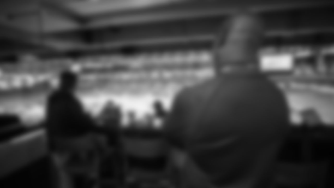 Head coach Anthony Lynn observes from inside the Chargers viewing suite at the 2019 NFL Scouting Combine at Lucas Oil Stadium in Indianapolis.