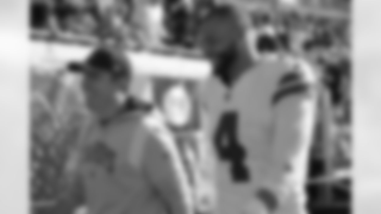 Dallas Cowboys quarterback Dak Prescott (4) and offensive coordinator Kellen Moore leave the field after the first half of an NFL football game against the Jacksonville Jaguars, Sunday, Dec. 18, 2022, in Jacksonville, Fla. (AP Photo/Phelan M. Ebenhack)
