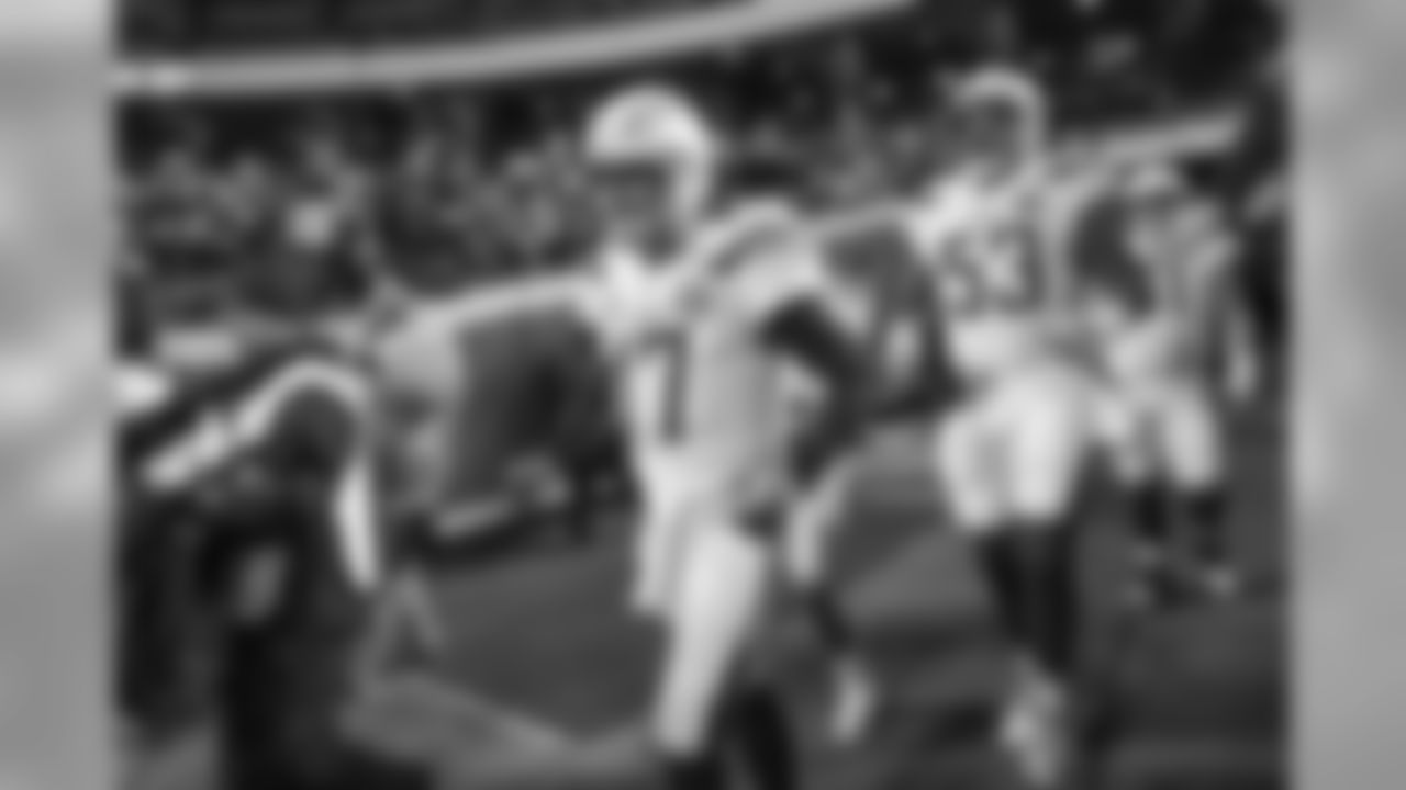 Philip Rivers and Mike Pouncey walk out to the field before the Thursday night matchup against the Kansas City Chiefs at Arrowhead Stadium.
