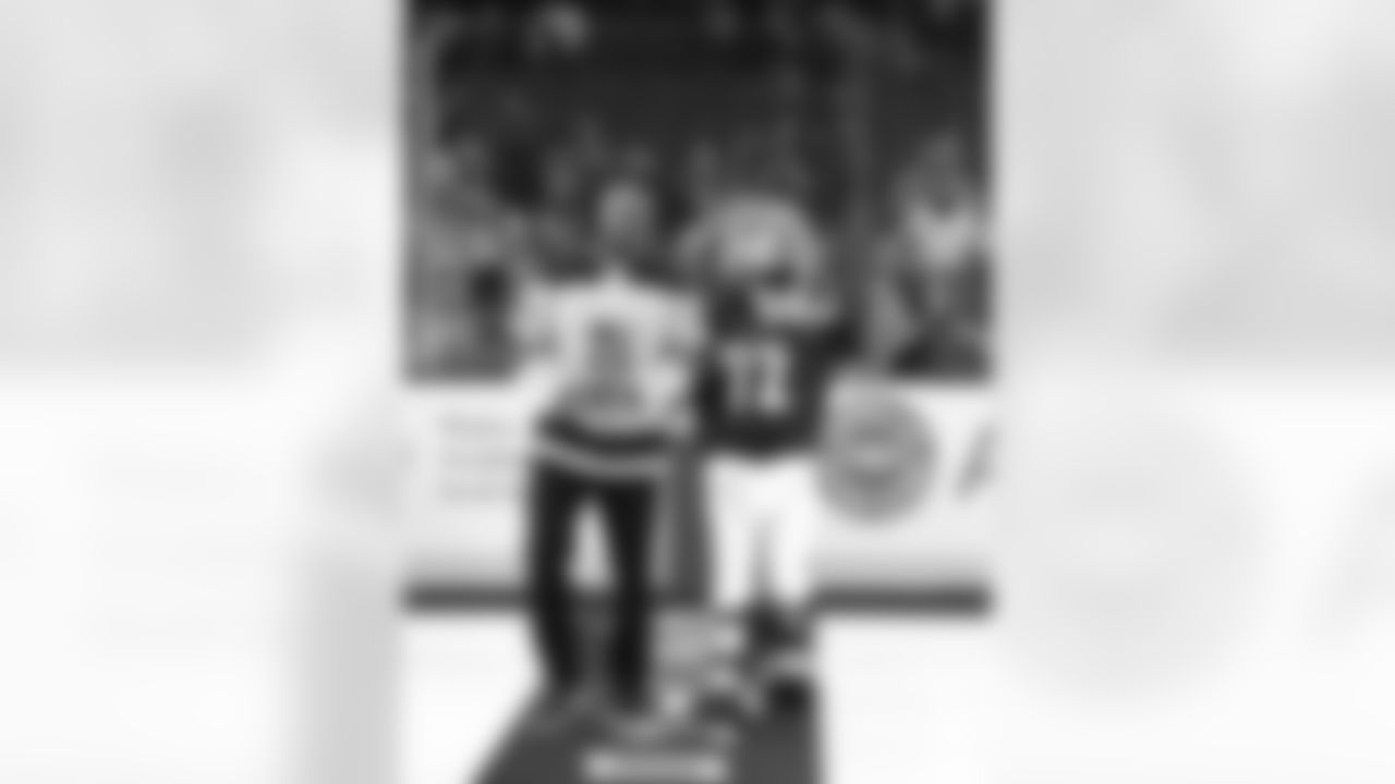 Chargers legend Marcellus Wiley and Los Angeles Kings mascot Bailey walk out for a ceremonial puck drop during the Winnipeg Jets vs. Kings game on December 18, 2018 at STAPLES Center.