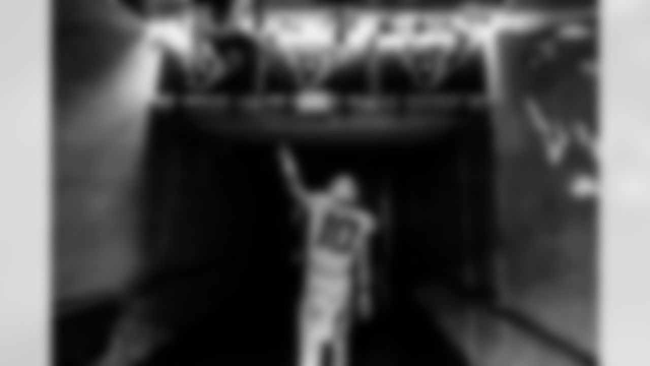 10 GETS BACK TO .500 - Here's Justin Herbert walking off with a win in Week 4 over the Houston Texans which got the team back to 2-2. The contrast here shows the fans peeking over the railing to get a glimpse of the Bolts' QB, but before he heads off into the dark tunnel, he acknowledges their presence and reciprocates the greeting. - Mike Nowak/Los Angeles Chargers