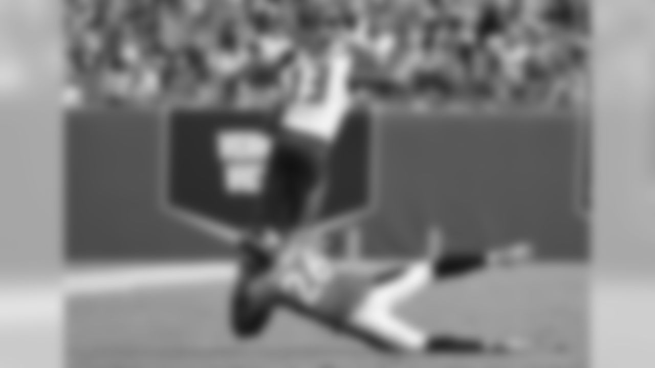 Tampa Bay Buccaneers wide receiver Mike Evans (13) dives from Denver Broncos safety Darian Stewart (26) for a gain in a week four NFL football game in Tampa, Fla. Denver won 27 - 7. (Al Messerschmidt via AP)
