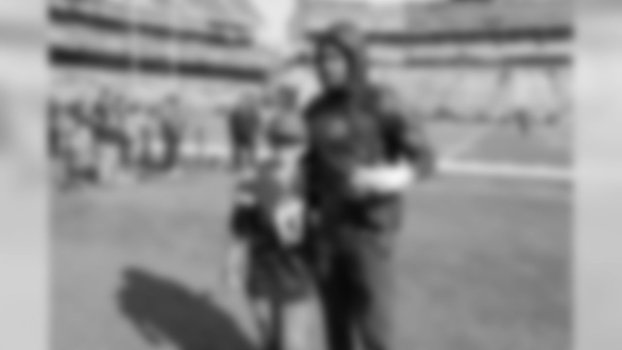 Jeff Richards poses with a fan at Oakland-Alameda County Coliseum before the Week 10 matchup against the Oakland Raiders.