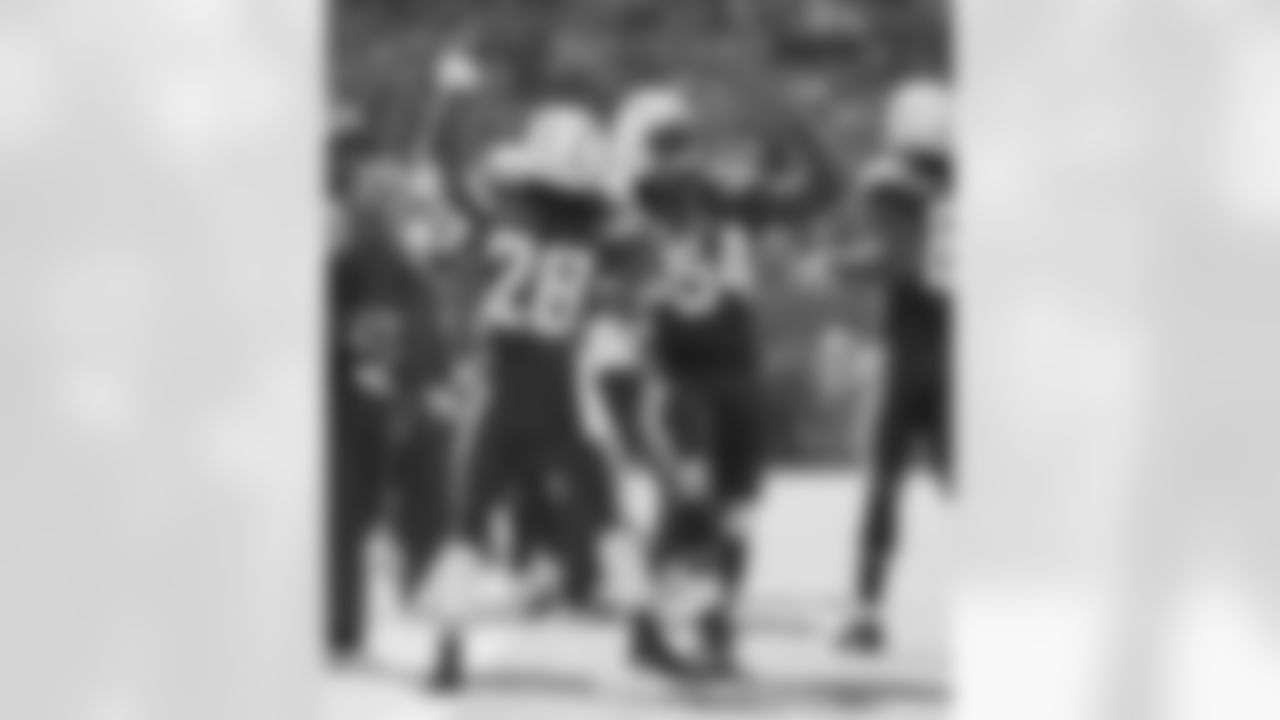 Melvin Gordon and Melvin Ingram do a handshake on the field during the Week 6 matchup against the Cleveland Browns.