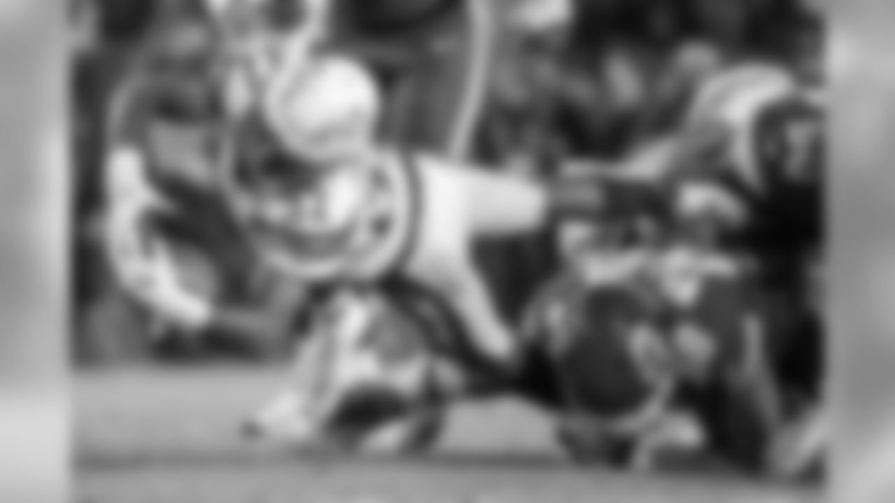 Justin Jackson extends the ball while being tackled during the Thursday night matchup against the Kansas City Chiefs at Arrowhead Stadium.