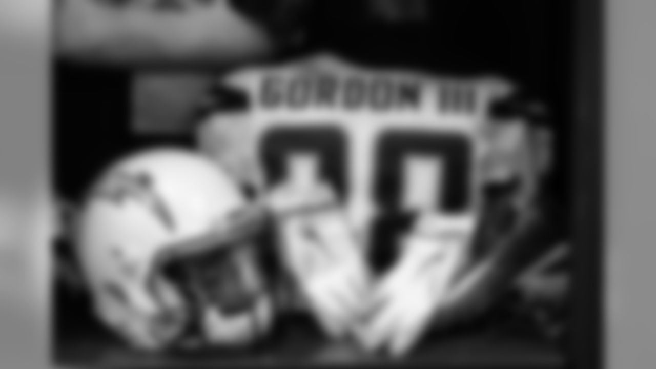 Melvin Gordon's helmet, jersey, gloves and cleats sit in the locker room before the Divisional Round matchup against the New England Patriots at Gillette Stadium.