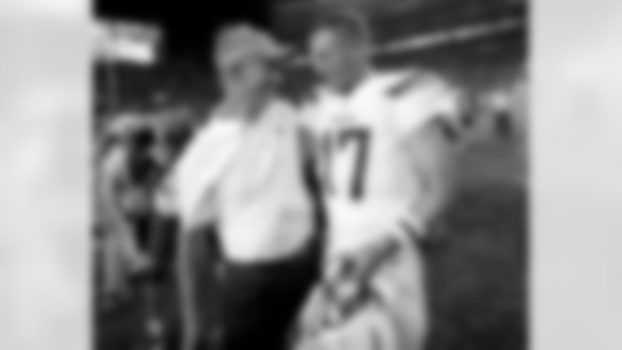 Los Angeles Chargers quarterback Philip Rivers (17) greets Denver Broncos offensive coordinator Mike McCoy after an NFL football game, Monday, Sept. 11, 2017, in Denver. The Broncos won 24-21. (AP Photo/David Zalubowski)