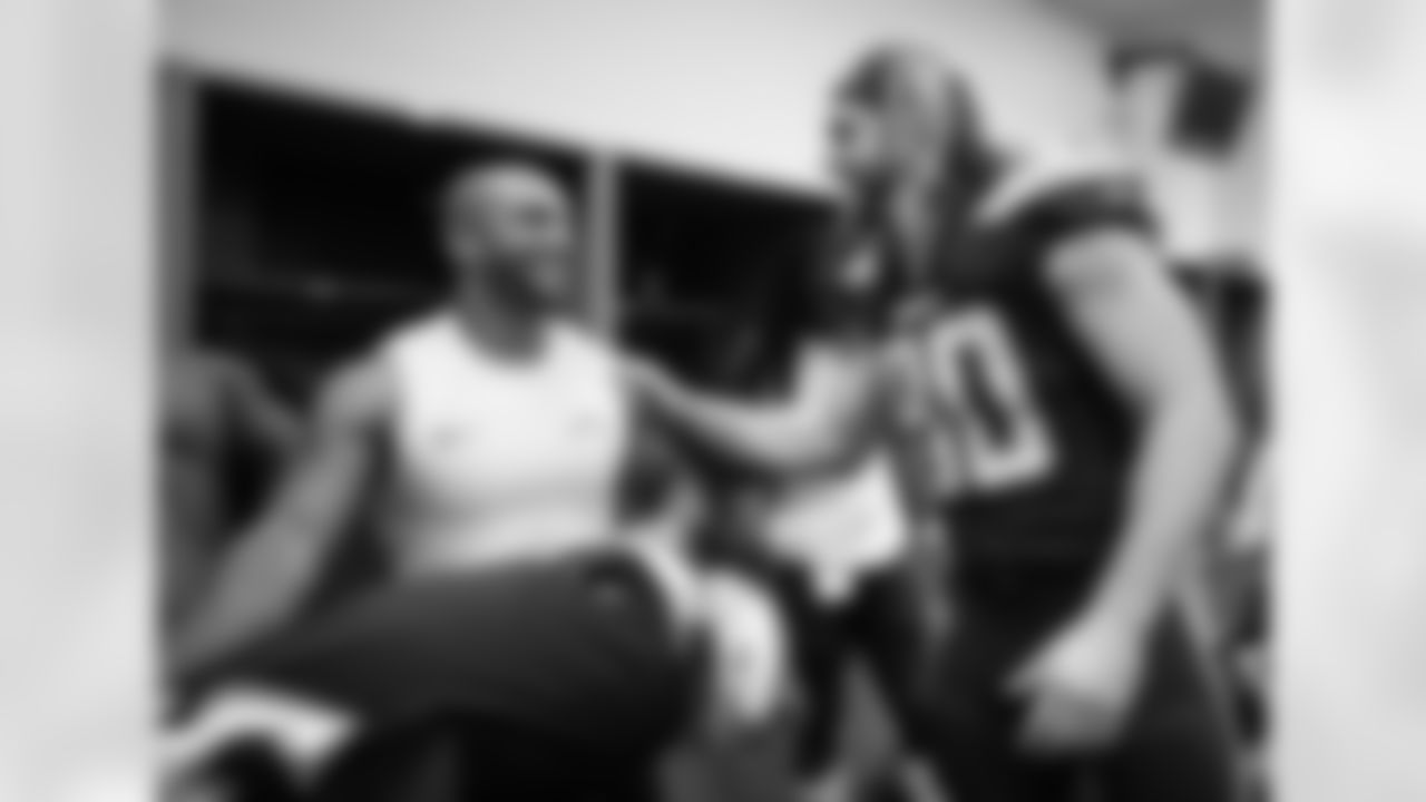 Austin Ekeler and Sean Culkin celebrate the Bolts' 38-14 win over the Cleveland Browns in the locker room.