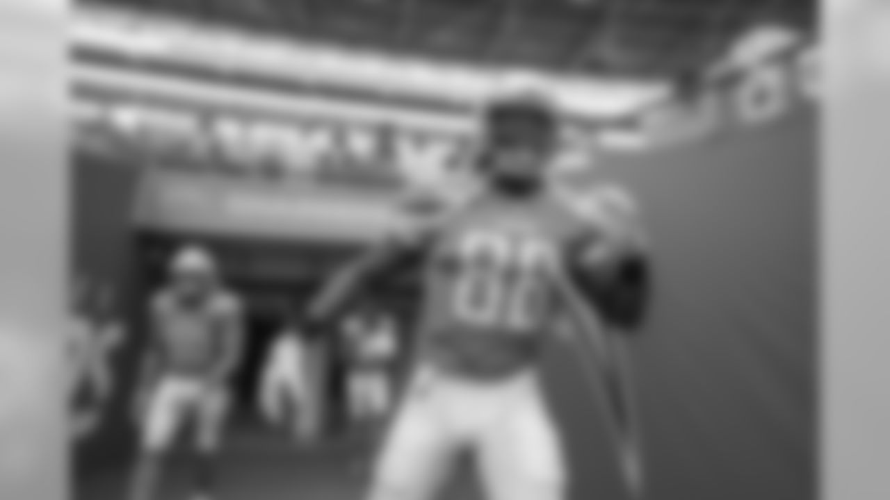 Virgil Green and Sean Culkin walk out to the field to warm up at Wembley Stadium in London before the Week 7 matchup against the Tennessee Titans.