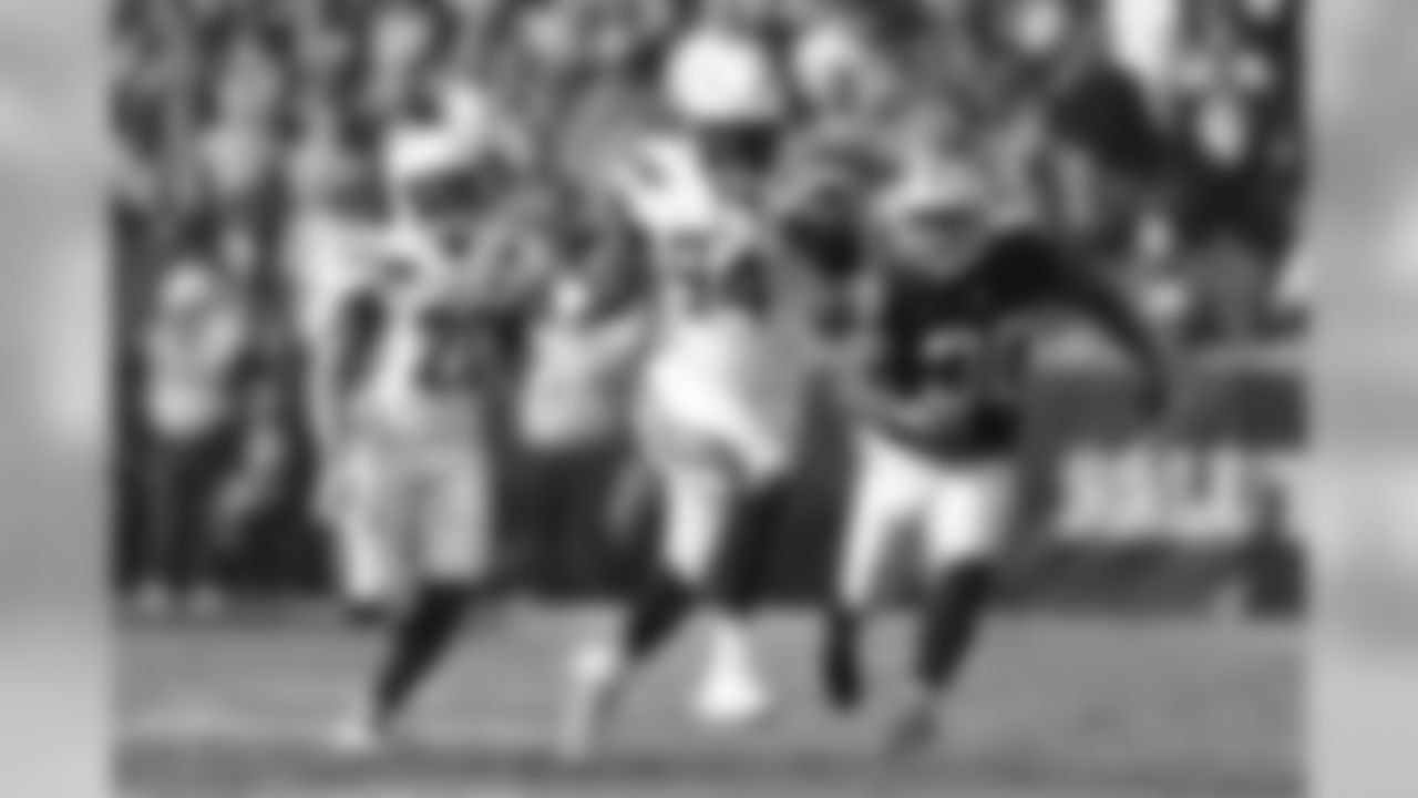 Corey Liuget runs the ball after a fumble recovery during the Week 10 matchup against the Oakland Raiders at Oakland-Alameda County Coliseum.