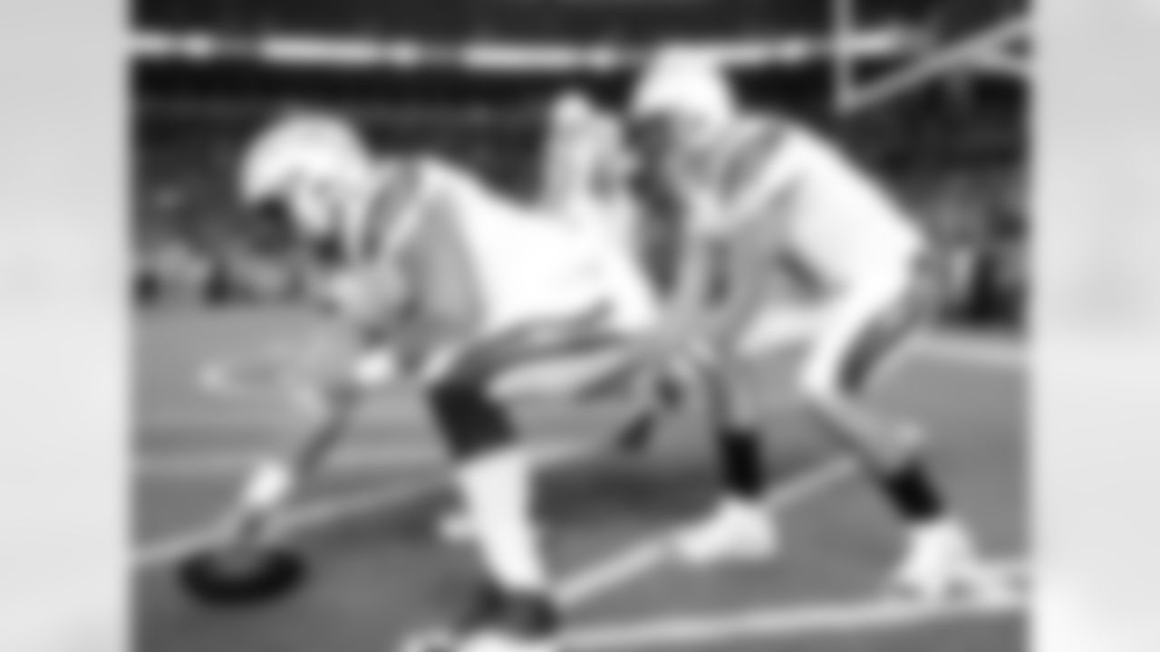 Los Angeles Chargers quarterback Philip Rivers (17) warms up under center Spencer Pulley prior to an NFL football game against the Denver Broncos, Monday, Sept. 11, 2017, in Denver. (AP Photo/Jack Dempsey)