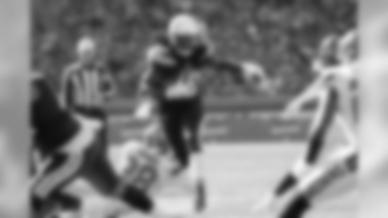 Melvin Gordon racing through Cleveland Browns players at FirstEnergy Stadium on Sunday, October 14, 2018.
