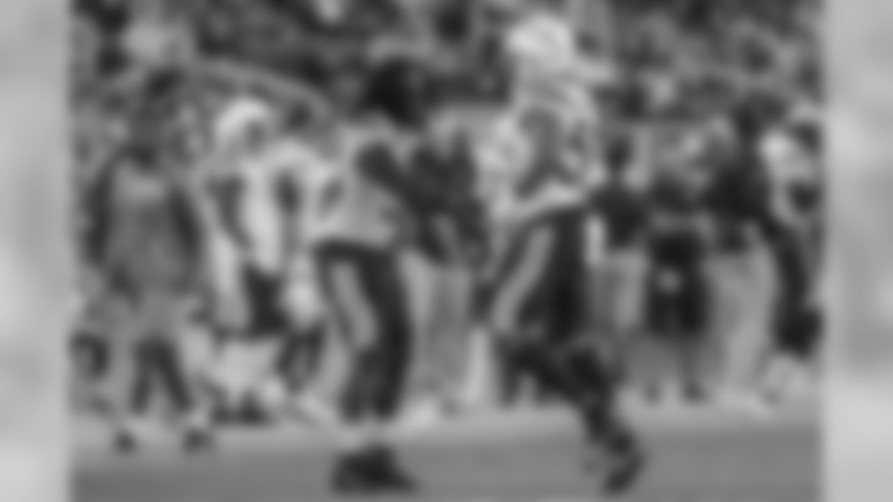 Melvin Ingram and Uchenna Nwosu celebrate Nwosu's tackle against the San Francisco 49ers during the last preseason game.