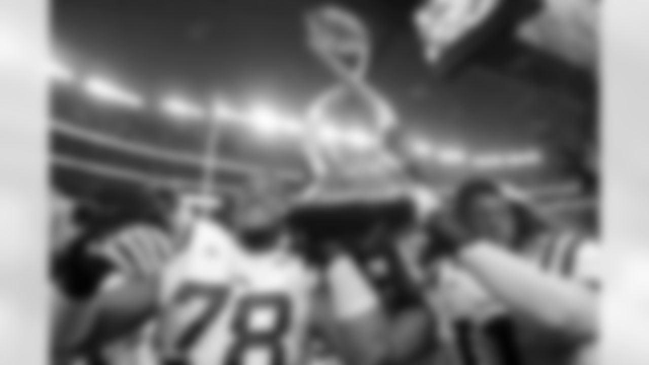 LSU players Joseph Barksdale, left, and Kelvin Sheppard carry the Cotton Bowl championship trophy after winning the NCAA college football game against Texas A&M 41-24, Friday, Jan. 7, 2011, in Arlington, Texas. (AP Photo/Tony Gutierrez)