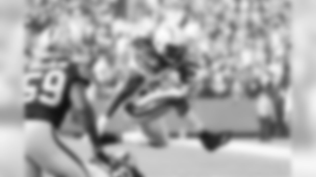 Melvin Gordon jumps over defenders during the Week 10 matchup against the Oakland Raiders at Oakland-Alameda County Coliseum.