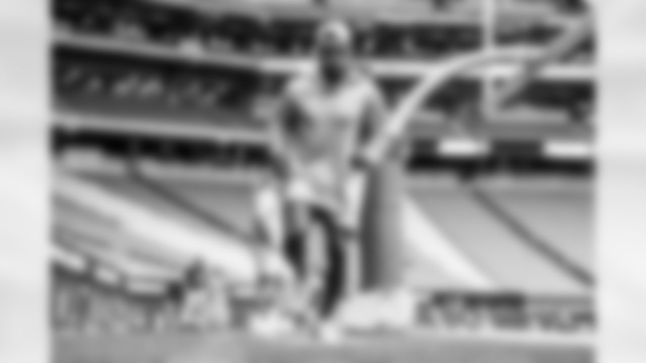 The Los Angeles Chargers prepare to play against the Arizona Cardinals at State Farm Stadium on November 27, 2022 in Glendale, Arizona.