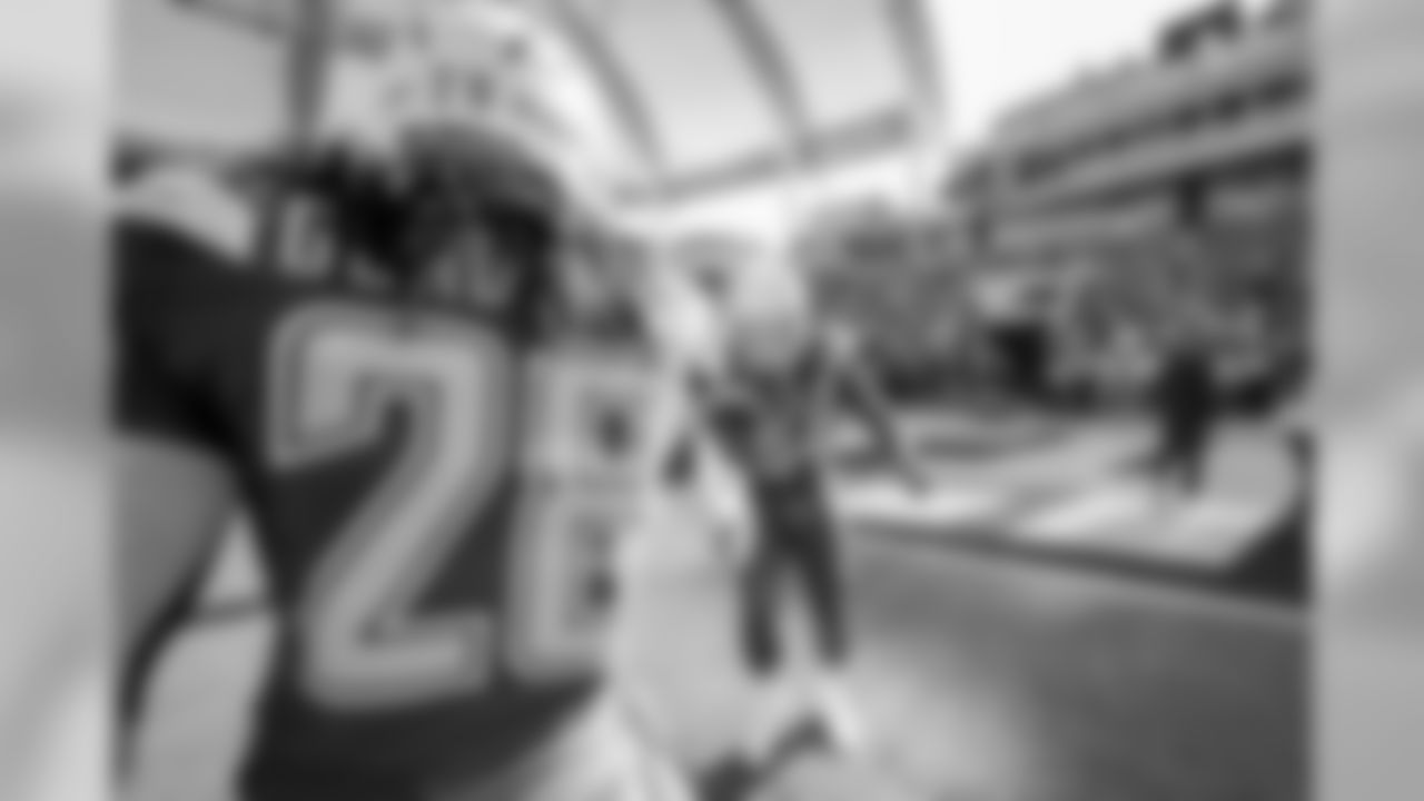 Melvin Gordon and Melvin Ingram shake hands on the field before the Week 12 matchup against the Arizona Cardinals.