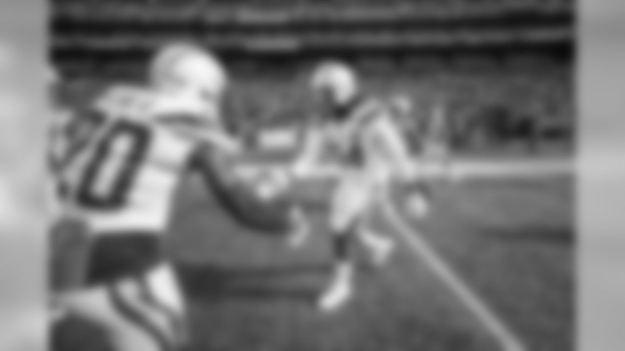 Desmond King and Melvin Ingram slap hands before the Week 9 matchup against the Seattle Seahawks at CenturyLink Field.