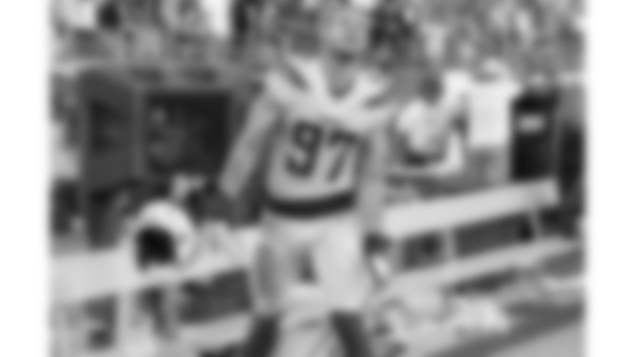 Confirmation Outburst - After standing up the QB sneak attempt on fourth and inches, an exhausted Joey Bosa made his way to the bench while the chain gang headed out onto the field. I kept the lens locked on him as he looked up at the jumbotron for the results, capturing a rare outburst of emotion when the late game stop was confirmed. - Ty Nowell/Los Angeles Chargers