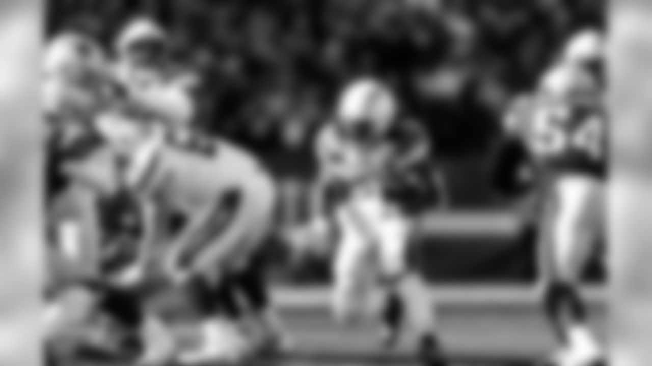 Melvin Gordon runs with the ball during the Divisional Round matchup against the New England Patriots at Gillette Stadium.