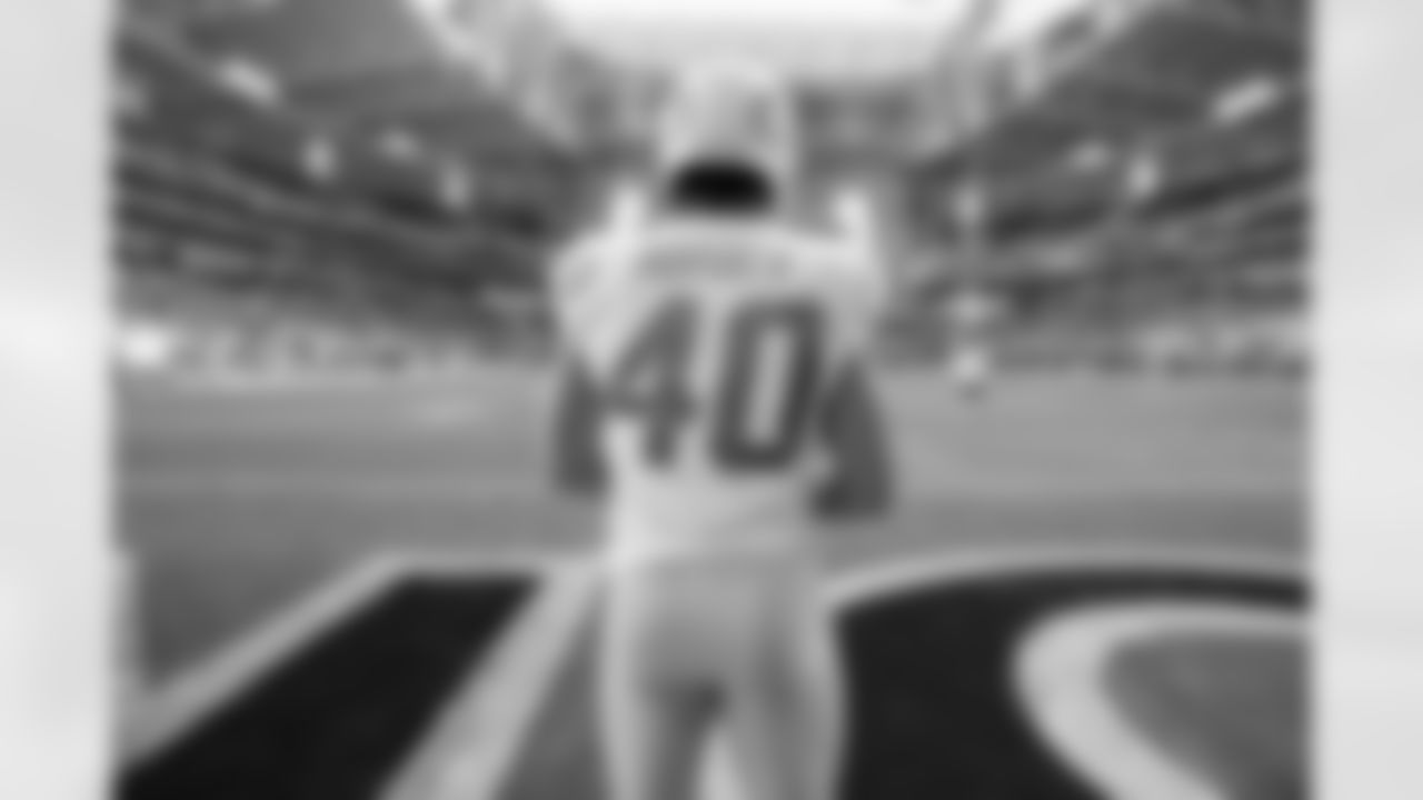 The Los Angeles Chargers prepare to play against the Arizona Cardinals at State Farm Stadium on November 27, 2022 in Glendale, Arizona.