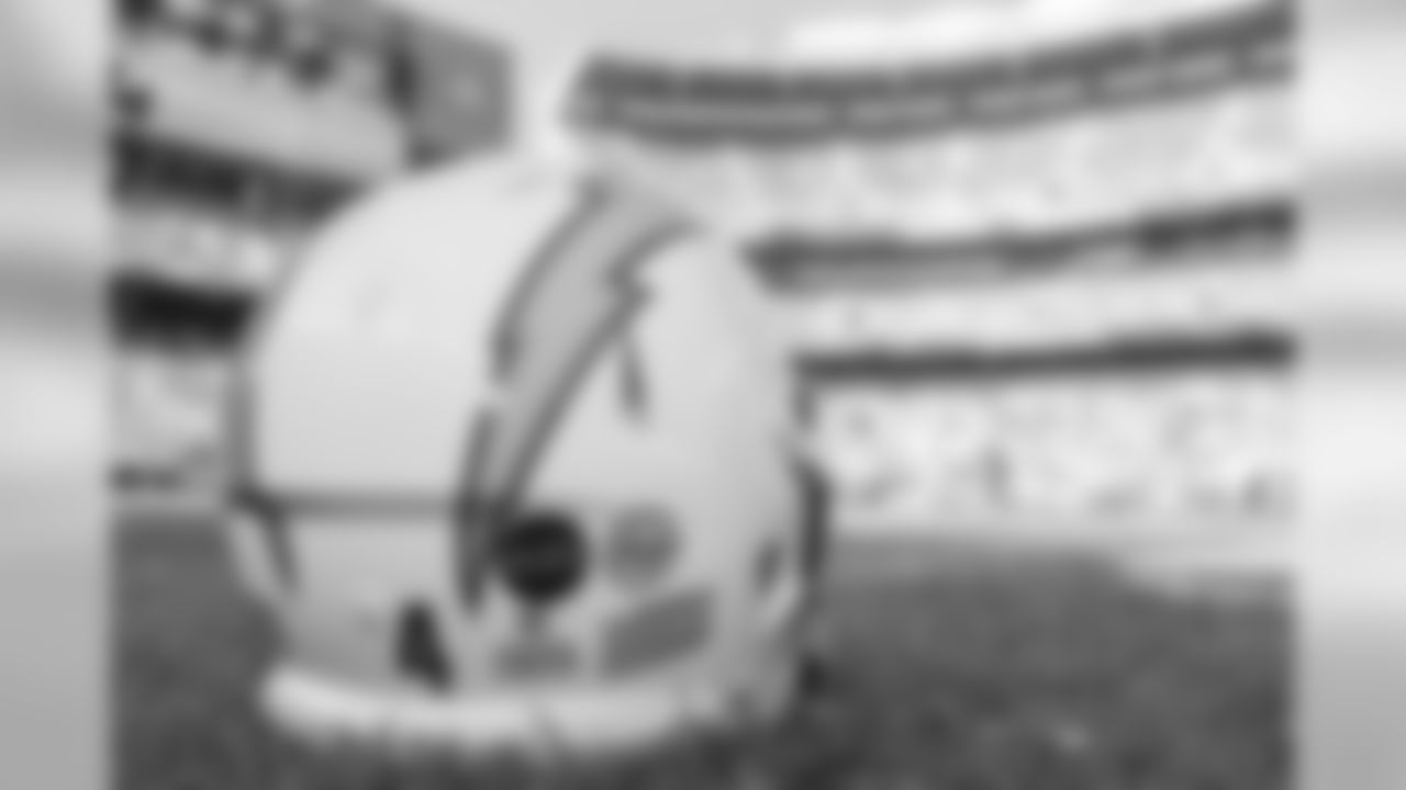 The Chargers' helmets feature stickers in remembrance of Alex and Faye Spanos.