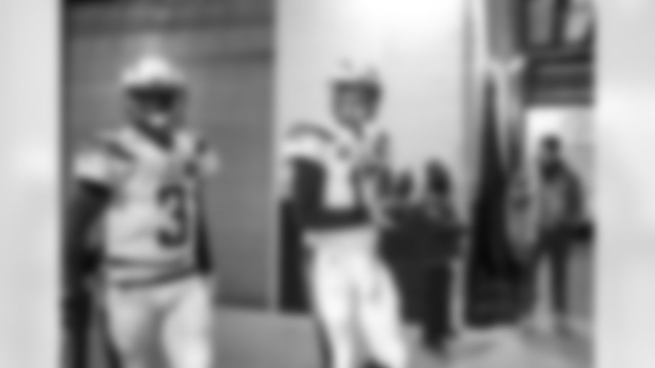 Geno Smith and Philip Rivers walk out to the field before the Divisional Round matchup against the New England Patriots at Gillette Stadium.