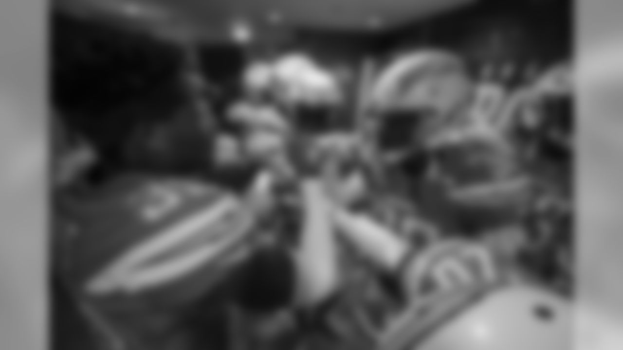 The Bolts huddle in the locker room at Wembley Stadium in London before the Week 7 matchup against the Tennessee Titans.