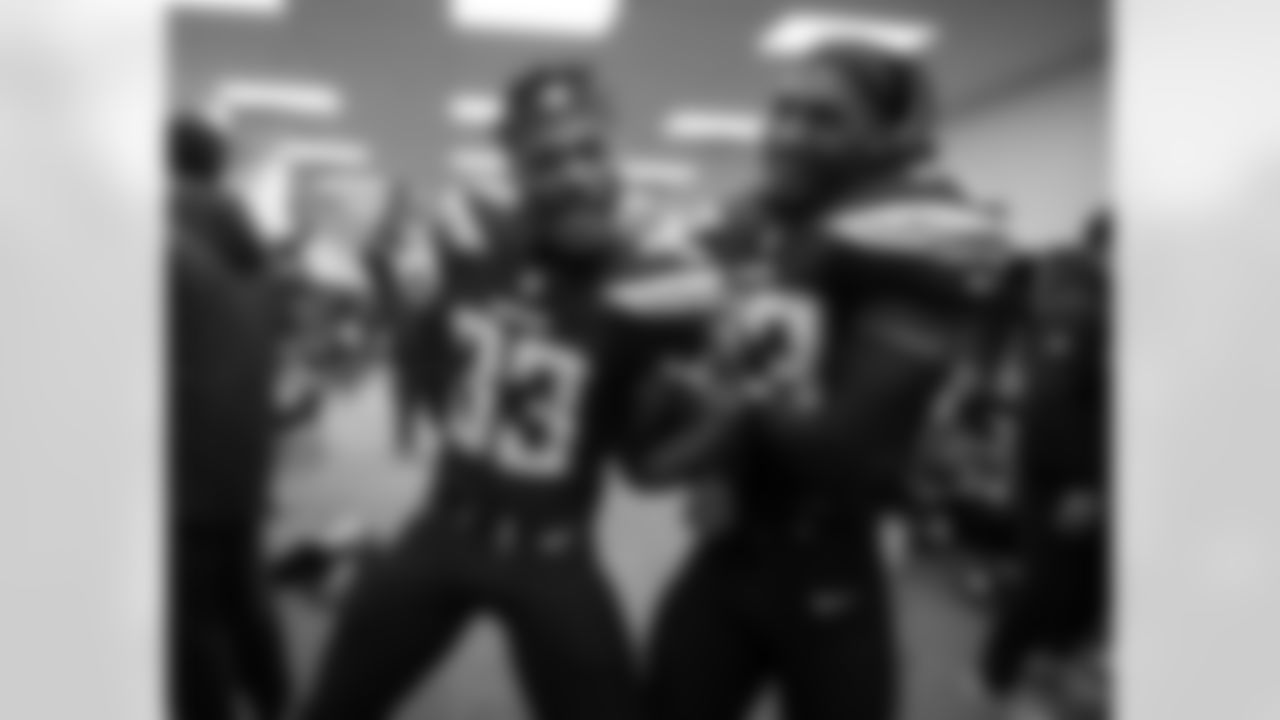 Derwin James and Rayshawn Jenkins celebrate the Bolts' 38-14 win over the Cleveland Browns in the locker room.
