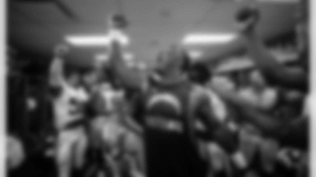 The team celebrates their 29-27 win over the 49ers in the locker room.