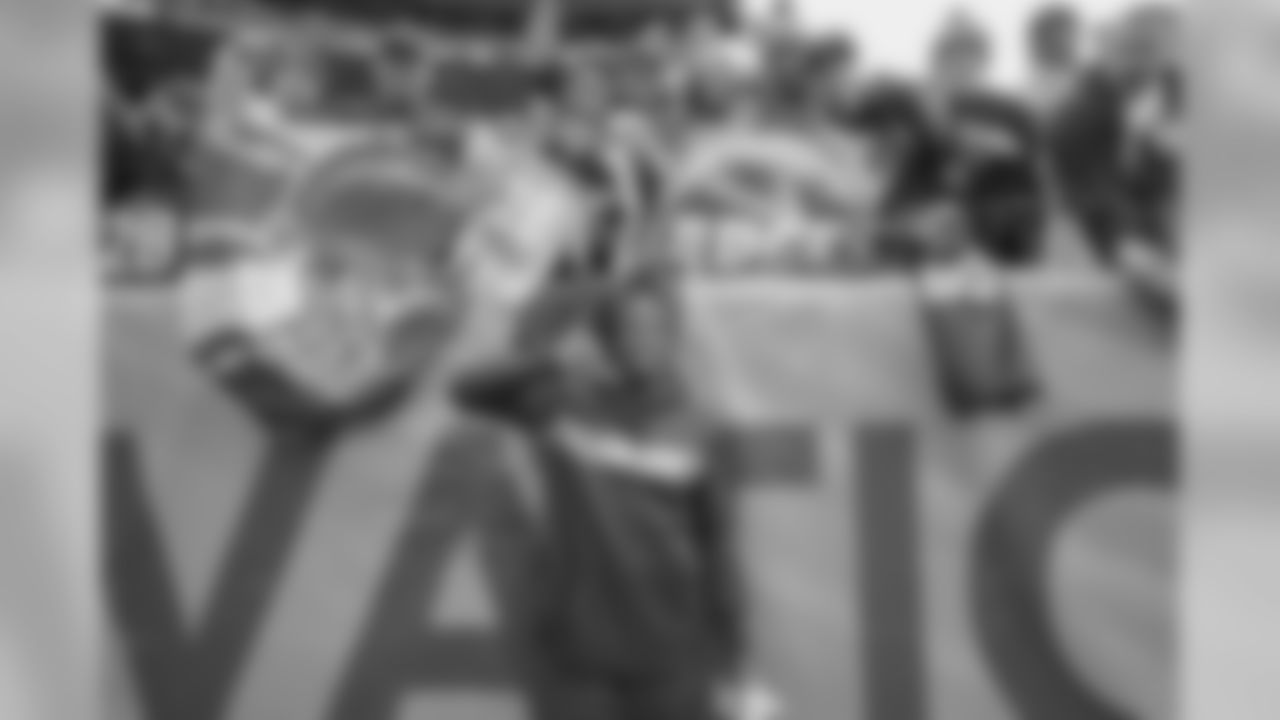 Melvin Gordon poses with fans before the Week 17 contest against the Denver Broncos.