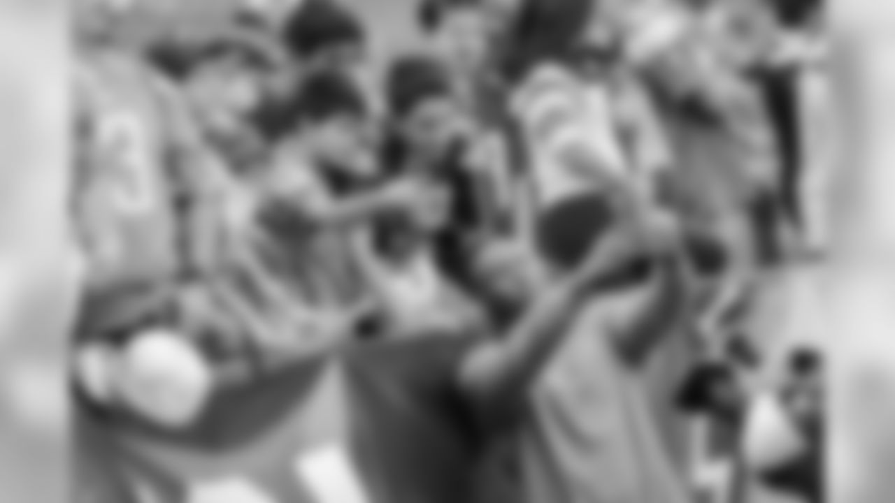 Uchenna Nwosu takes pictures with fans before the Week 14 matchup against the Cincinnati Bengals at ROKiT Field at StubHub Center.