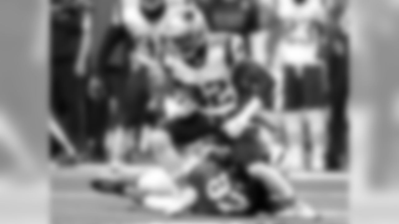 Indianapolis Colts wide receiver Reggie Wayne, bottom, attempts to tackle New England Patriots free safety Devin McCourty after McCourty intercepted a pass from Indianapolis Colts quarterback Andrew Luck during the first half of an NFL football game in Indianapolis, Sunday, Nov. 16, 2014.