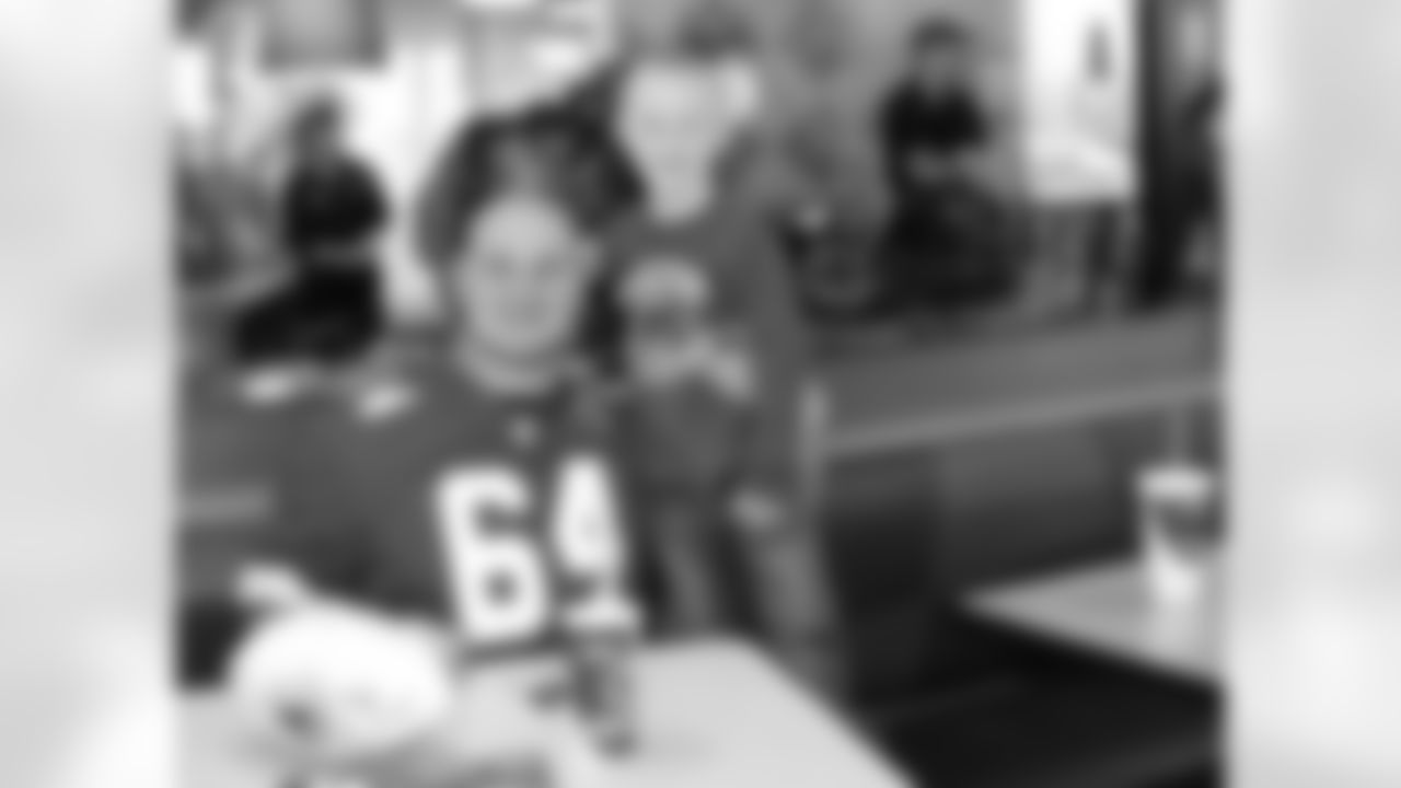 Demetrius Harris, Eric Kush and Jon Asamoah sign autographs in support of First Downs for Down Syndrome at a KFC in Kansas City.