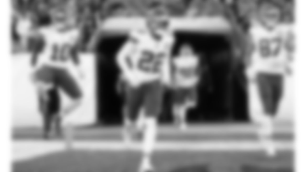 Kansas City Chiefs running back Isiah Pacheco (10), defensive back Juan Thornhill (22) and tight end Travis Kelce (87) run on to the field prior to an NFL football game against the Denver Broncos, Sunday, December 11, 2022 in Denver.